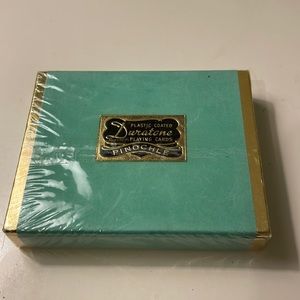 Duratone plastic coated playing cards in floral print in the back.